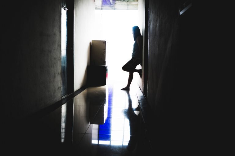 depress and hopeless woman standing the dark at corridor